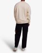 Hombre con Sudadera Oversize Deus Caution Crew Blanco Sucio espalda